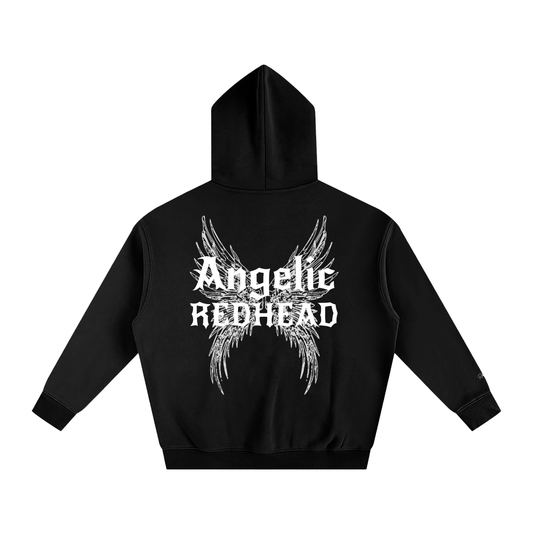 black oversized fleeced hoodie with a back print featuring white gothic “Angelic Redhead” text layered over large angel wing artwork.
