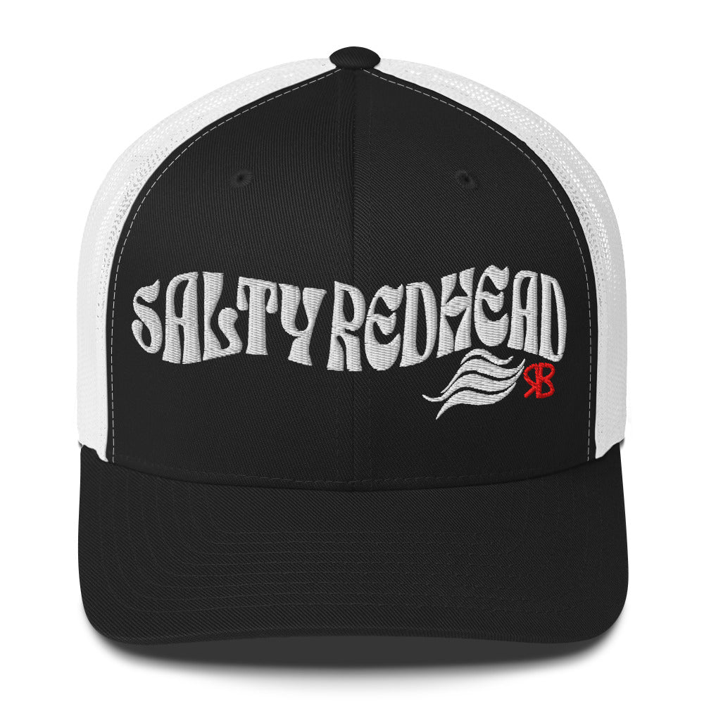 black/white trucker cap with 'Salty Redhead' in white Solino display font. Branded RB in red