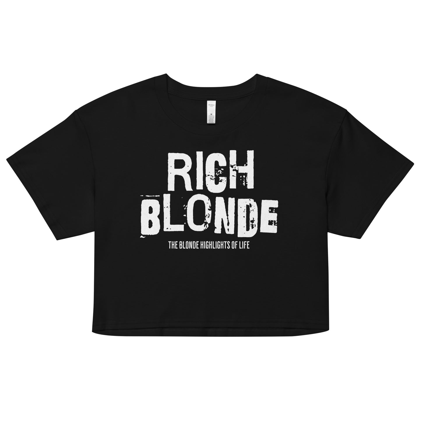 A black women’s crop top with a relaxed fit, short sleeves, and a wide crew neckline. The front features bold white distressed lettering reading “RICH BLONDE” with the tagline “THE BLONDE HIGHLIGHTS OF LIFE” in smaller text below.