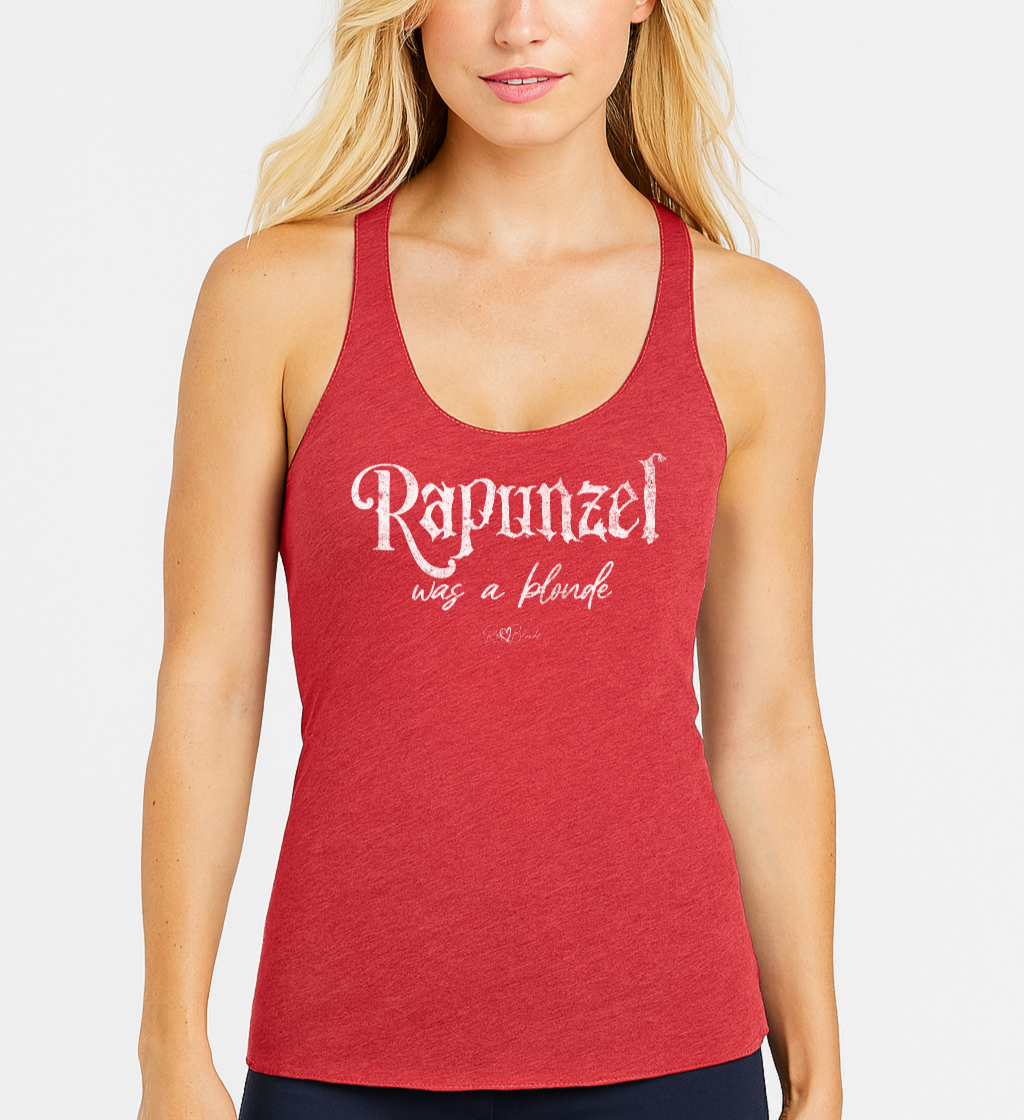 blonde wears a red women’s racerback tank featuring white fairytale spiky text that reads “Rapunzel" and the phrase “was a blonde” written underneath in an elegant cursive script. signed off with the RedBlonde heart signature logo