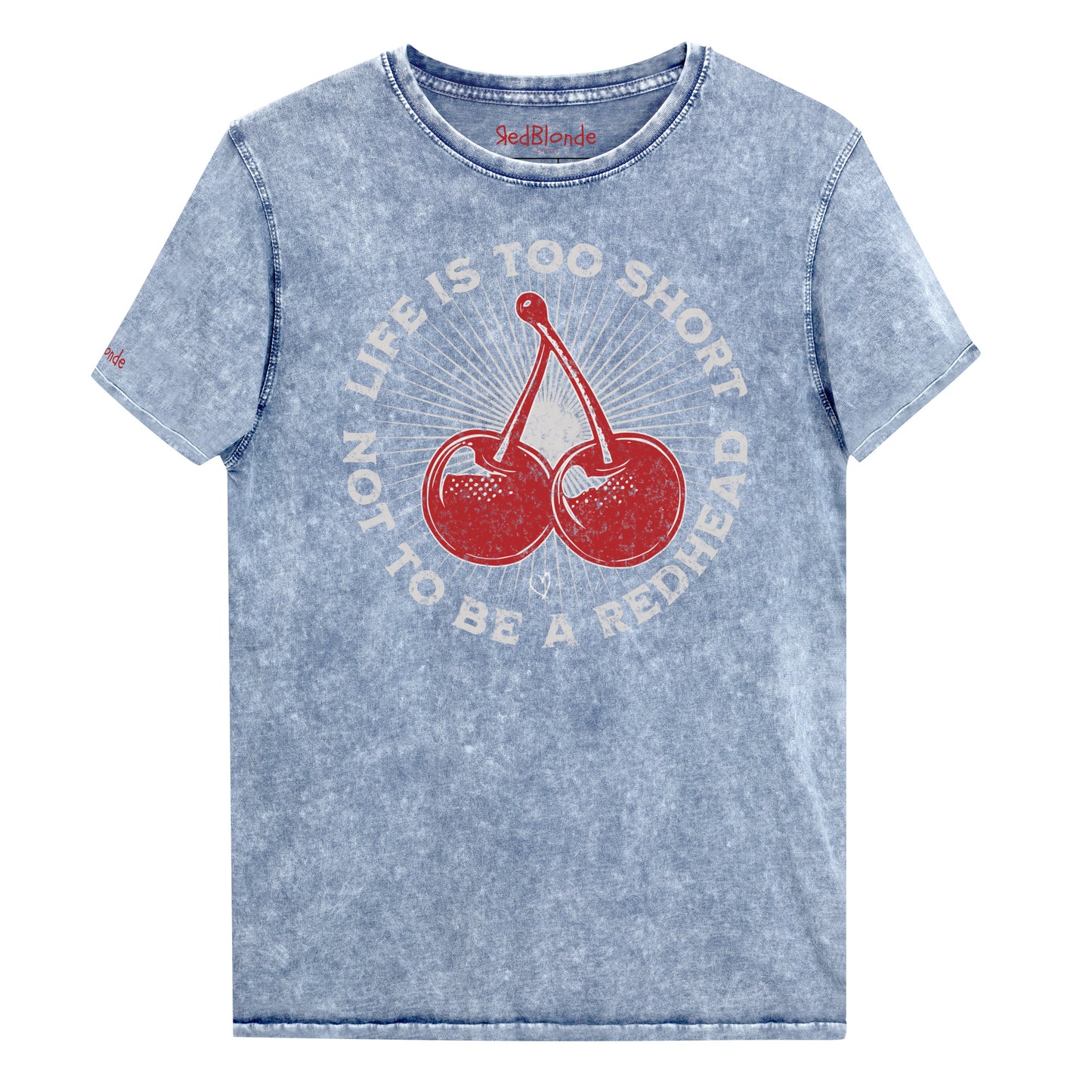 denim blue acid-wash unisex T-shirt featuring a bold red cherry graphic in the center. Surrounding text reads “Life is too short not to be a redhead” in distressed white adventure font lettering. The inside neck and sleeve also feature the RedBlonde logo in red.