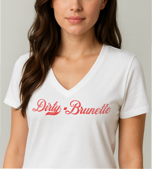 brunette wears a white relaxed fit V-neck t-shirt with “Dirty Brunette” written in vintage Coca-Cola red script on the front. Branded RedBlonde on inside neck and right shoulder in red