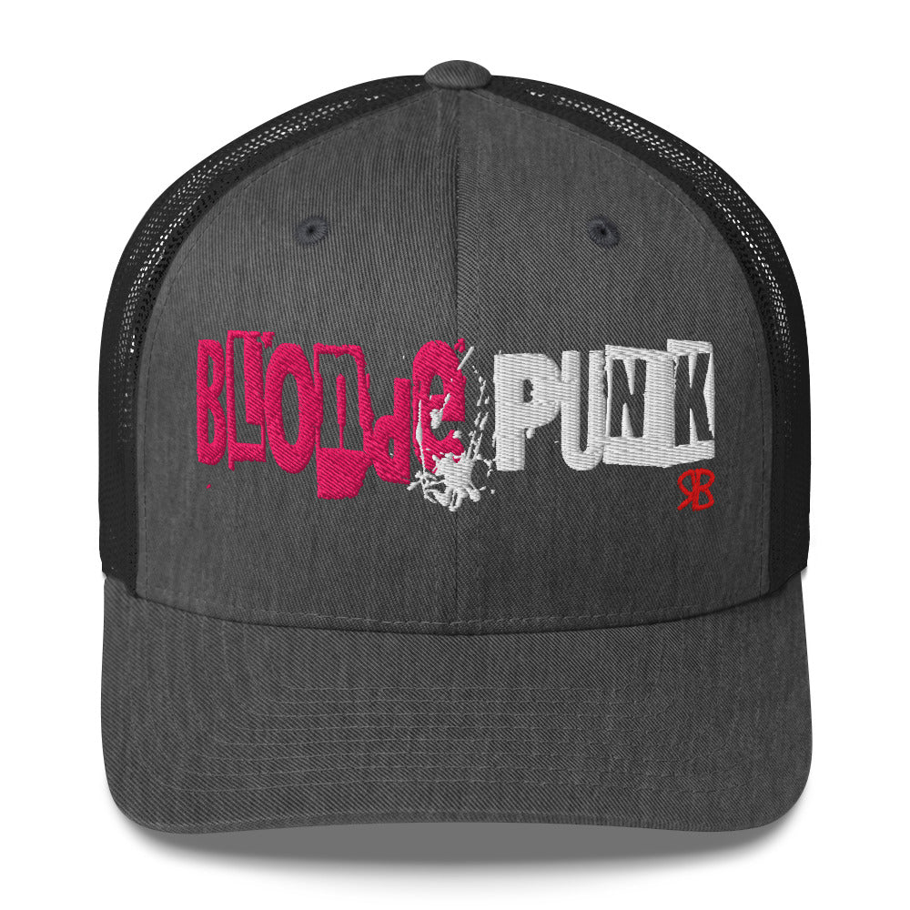 dark grey/black trucker cap with 'Blonde Punk' in irregular printing block style caps and lowercase. Blonde is written in bright pink and Punk in black lettering. Branded RB in red