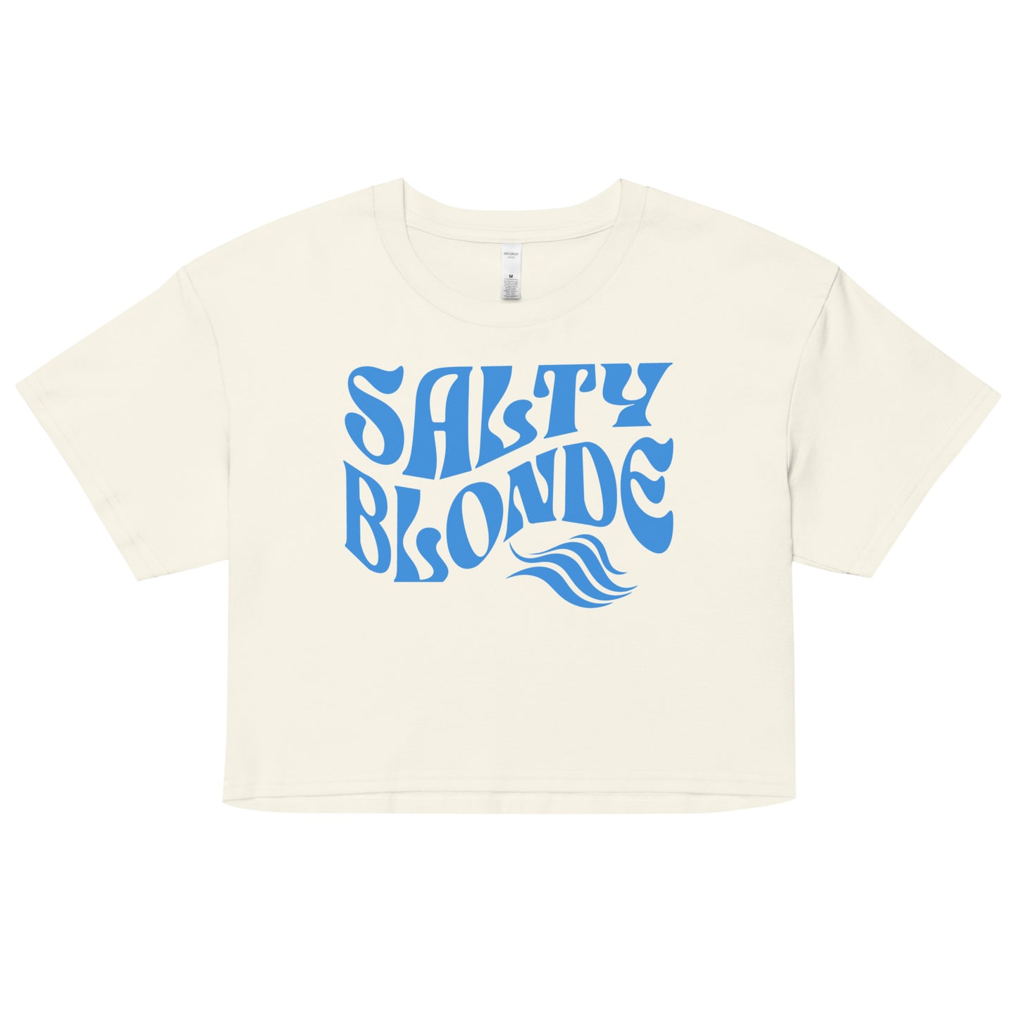 Flatlay of a ecru loose crop top t-shirt with the words ‘Salty Blonde’ in blue retro 70s wavy font