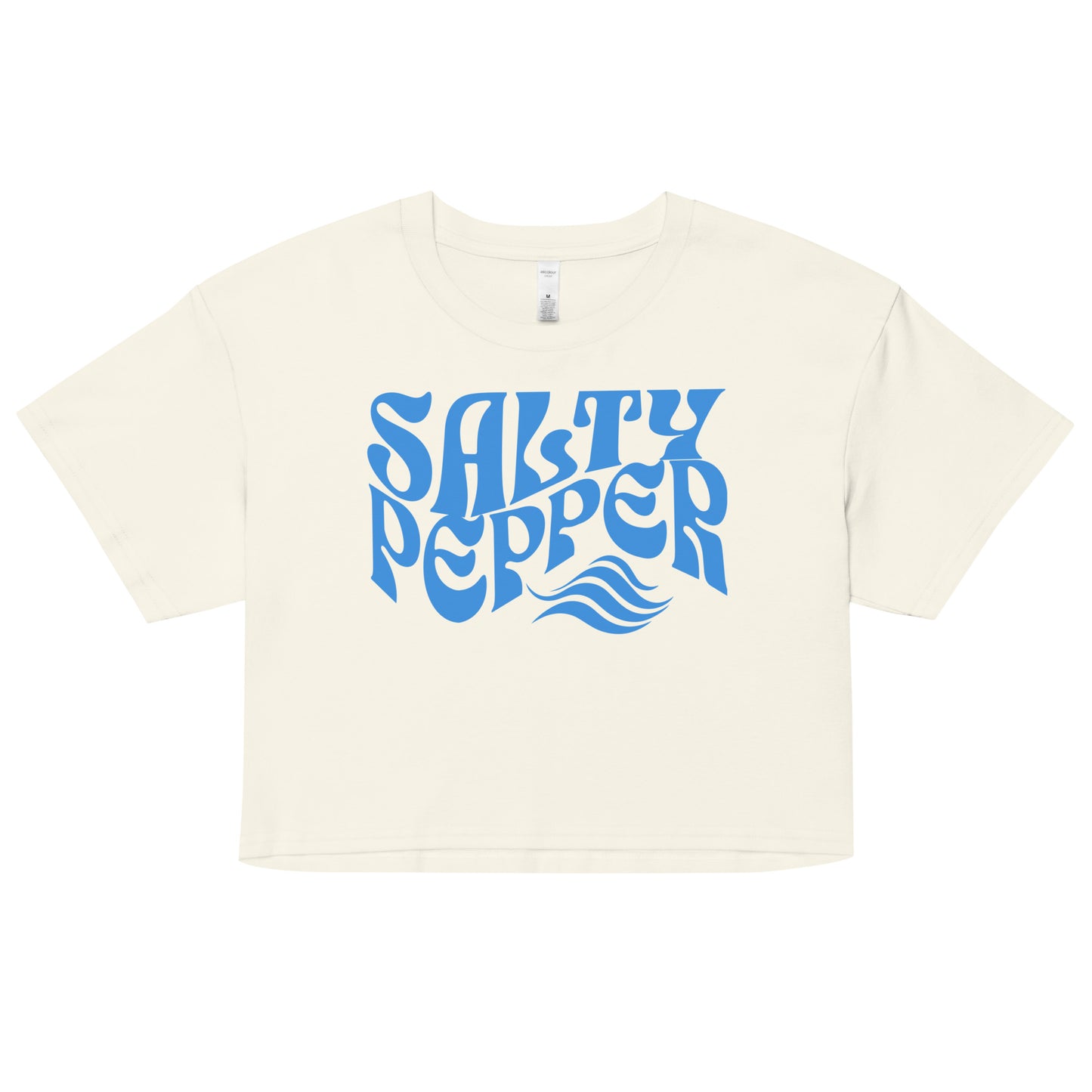 Flatlay of a ecru white loose women's crop top t-shirt with the words ‘Salty Pepper’ in blue retro wavy 70s font