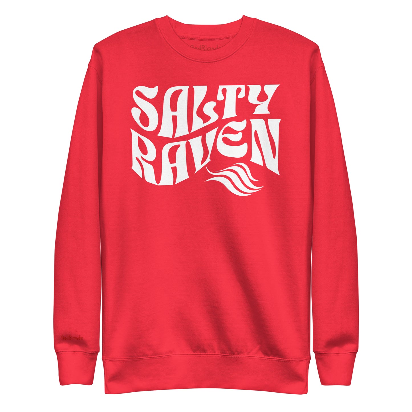 flatlay of Classic relaxed fit unisex sweatshirt in red with 'Salty Raven' play on words slogan in white retro wavy 70s text. Branded RedBlonde on inside neck and right cuff in red