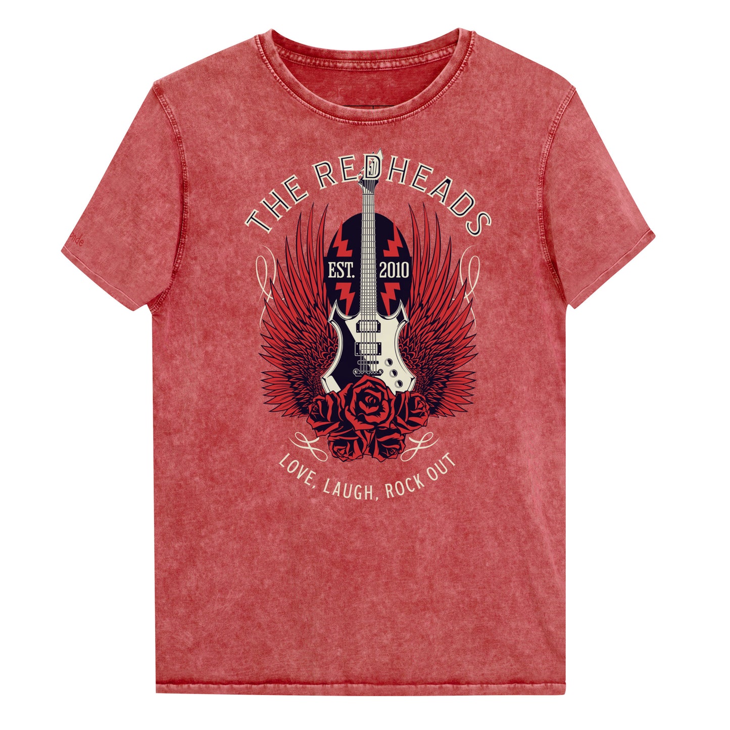 A flatlay of a garnet red denim wash unisex t-shirt with a graphic of a black & white guitar with red bird wings emerging from the side. The graphic features ‘THE REDHEADS' in Brookfield font in a semicircle above the guitar, while ‘Love, laugh, rock out’ is underneath. Branded RedBlonde London in inside neck and right sleeve