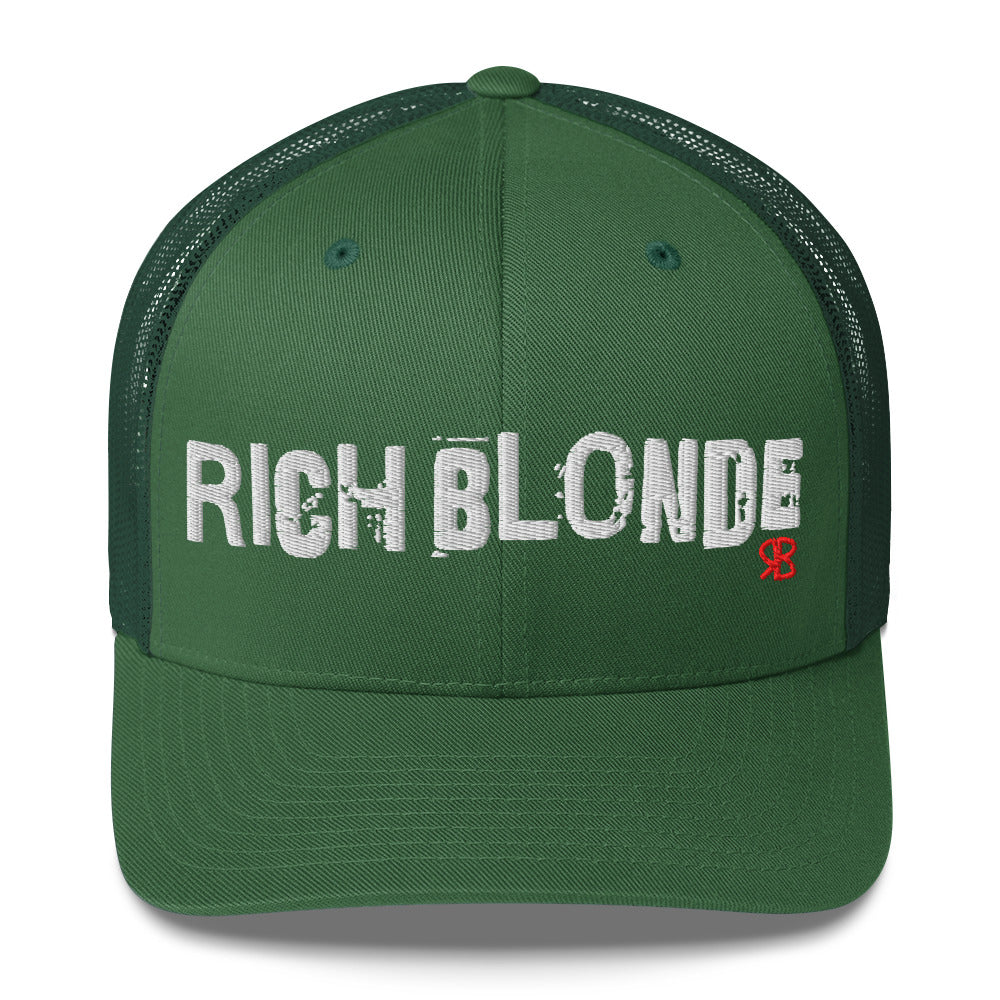 green mesh-back trucker cap with the bold distressed text “RICH BLONDE” embroidered in white across the front, and a small red “RB” logo detail beneath the text. The cap has a structured front panel and curved brim