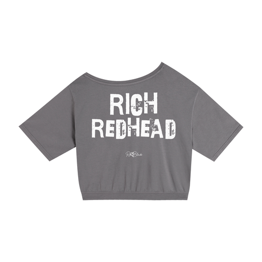 grey asymmetrical shoulder t-shirt with bold white Ed Gein font “RICH REDHEAD" slogan on the front and RedBlonde logo beneath.