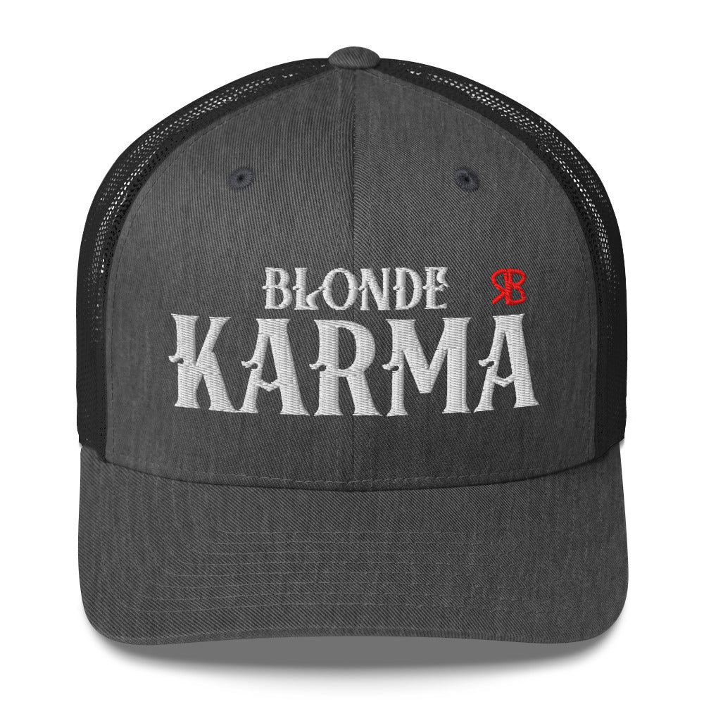 grey and black retro trucker cap with mesh back. The front features bold white embroidered text reading "BLONDE KARMA" with a small red RB logo to the right.