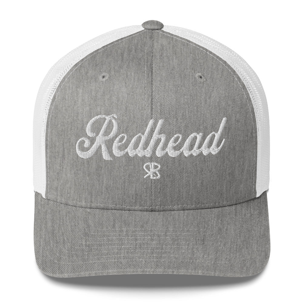 grey/white trucker cap with 'Redhead' in white adventurer 01 font on front. Mesh back. Branded RB