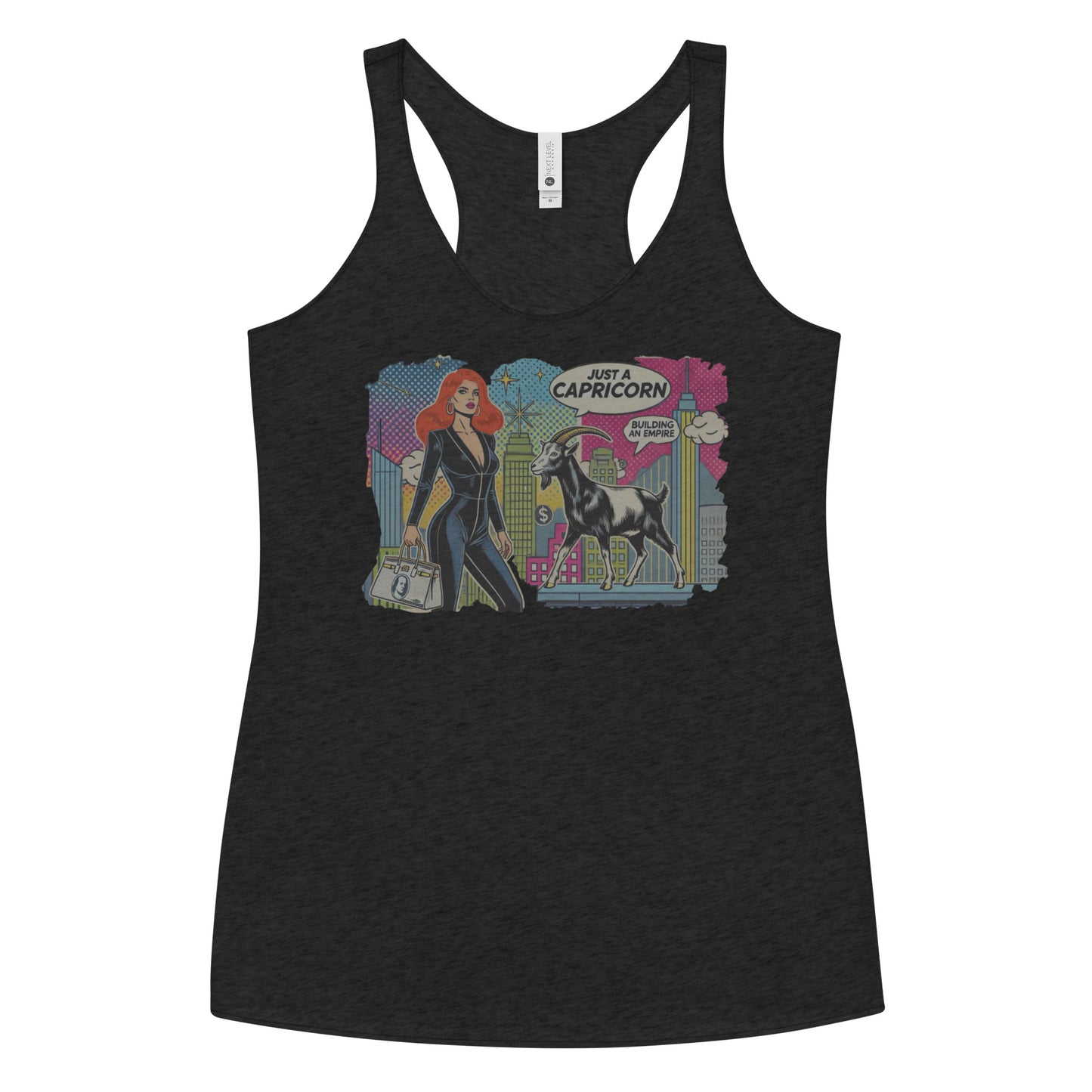 Flatlay of a heather black soft racerback tank t-shirt with a retro pop-art Redhead Capricorn graphic featuring a redhead woman in a black catsuit, carrying a bag, with a goat and a city skyscraper backdrop, captioned ‘Just a Capricorn, Building an empire'