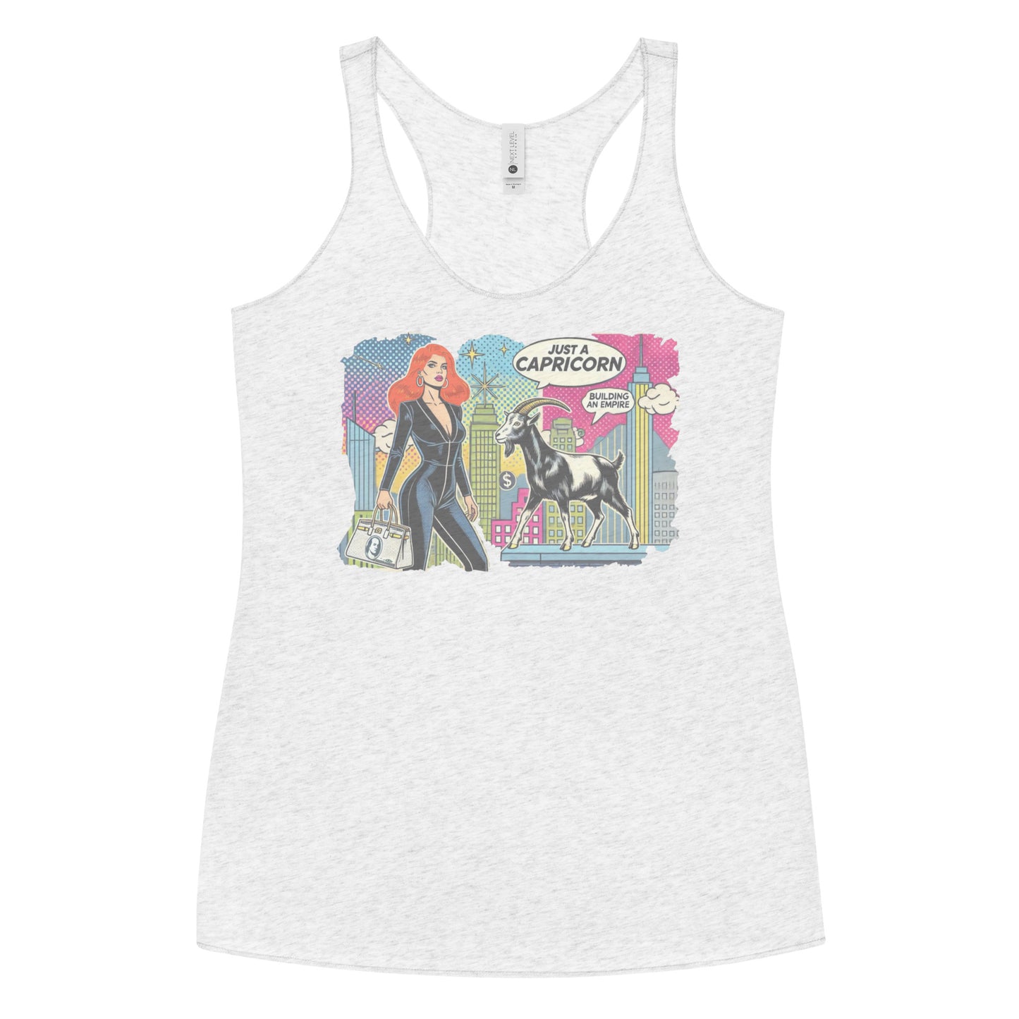 Flatlay of a heather white soft racerback tank t-shirt with a retro pop-art Redhead Capricorn graphic featuring a redhead woman in a black catsuit, carrying a bag, with a goat and a city skyscraper backdrop, captioned ‘Just a Capricorn, Building an empire'