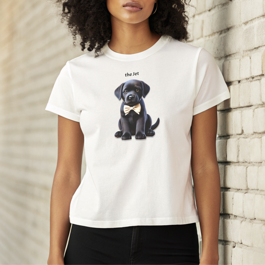 high waisted relaxed white t-shirt with cute graphic of jet black puppy wearing a bow-tie and the words 'the Jet' linking to black hair. the t-shirt is worn by a black model with black hair