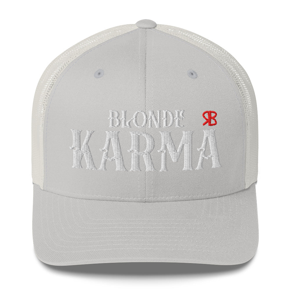 light gray/white retro trucker cap with mesh back. The front features bold white embroidered text reading "BLONDE KARMA" with a small red RB logo to the right.