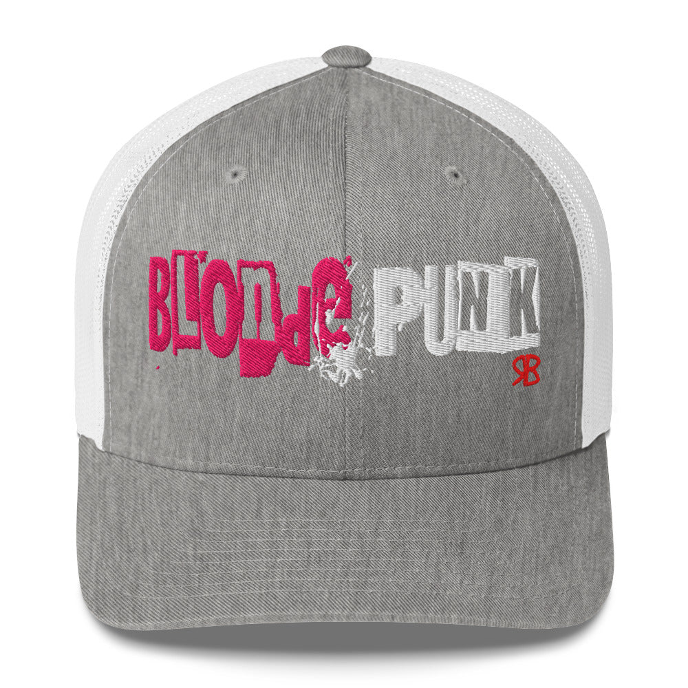 light gray/white trucker cap with 'Blonde Punk' in irregular printing block style caps and lowercase. Blonde is written in bright pink and Punk in black lettering. Branded RB in red