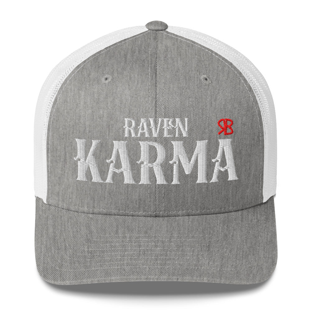 light grey / white retro trucker cap with mesh back. The front features bold white embroidered text reading "RAVEN KARMA" with a small red RB logo to the right.