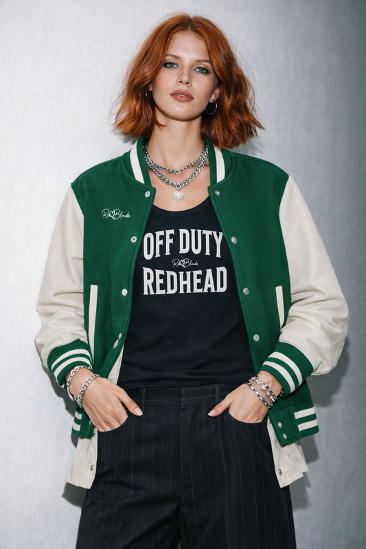 model wears a black sleeveless vintage acid wash tank top laid flat on a white background, with white text on the chest reading “OFF DUTY REDHEAD” in bold Brookfield lettering, and a small cursive RedBlonde signature logo between the words.