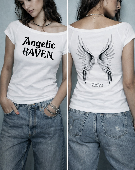 Raven haired model wears a White wide-neck t-shirt featuring detailed silver angel wings and the RedBlonde signature logo beneath the design.