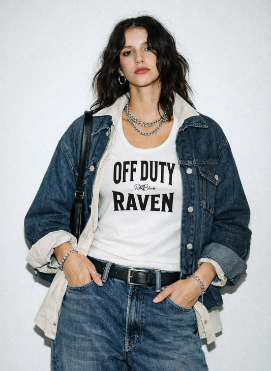 model wears a white sleeveless vintage acid wash tank top laid flat on a white background, with Black text on the chest reading “OFF DUTY RAVEN” in bold Brookfield lettering, and a small cursive RedBlonde signature logo between the words.