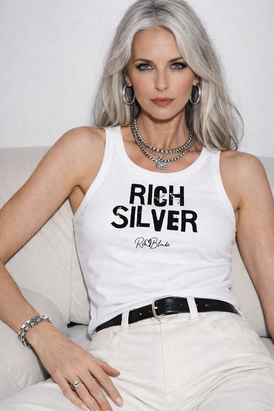 Model wears white acid-wash vintage tank top with bold white Ed Gein font “RICH SILVER" slogan on the front and RedBlonde logo beneath.