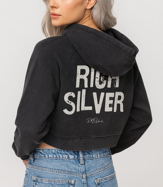 model wears a cropped snow-wash black hoodie with bold black “RICH SILVER” Ed Gein font and the RedBlonde signature logo printed below.