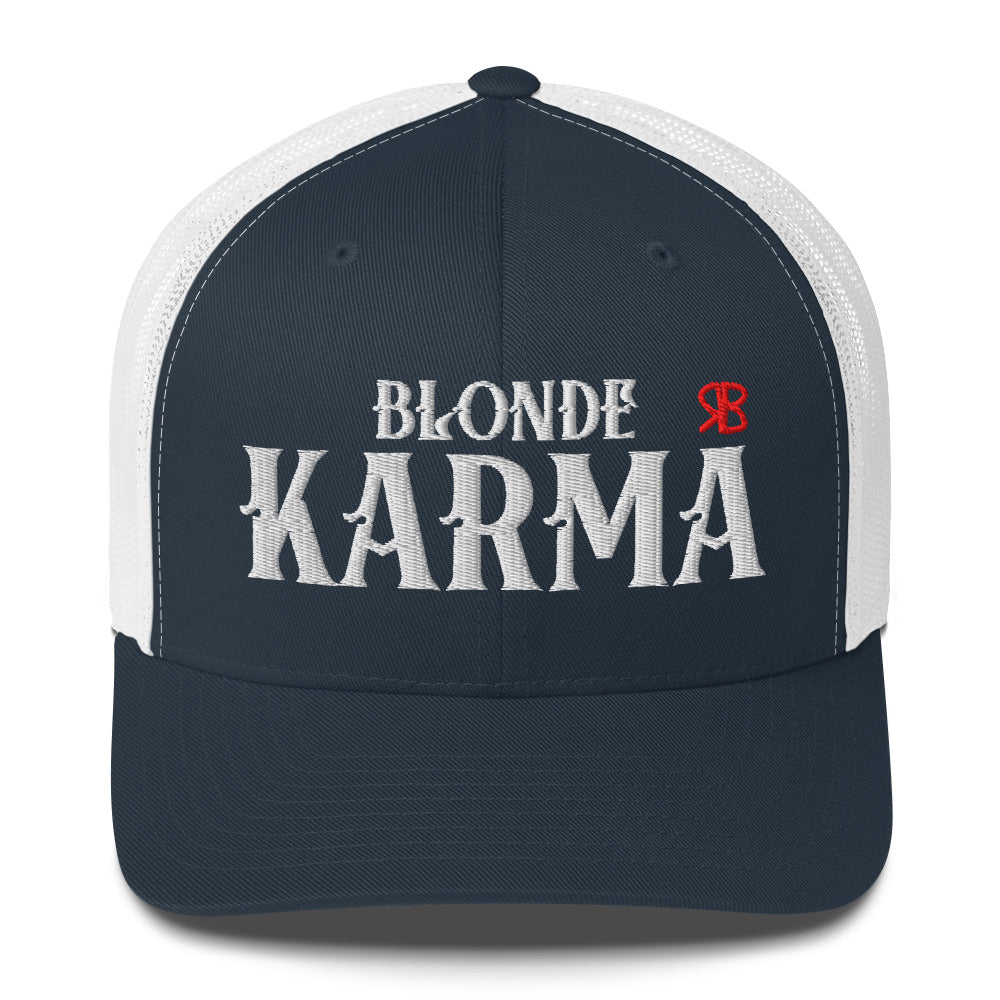 navy and white retro trucker cap with mesh back. The front features bold white embroidered text reading "BLONDE KARMA" with a small red RB logo to the right.