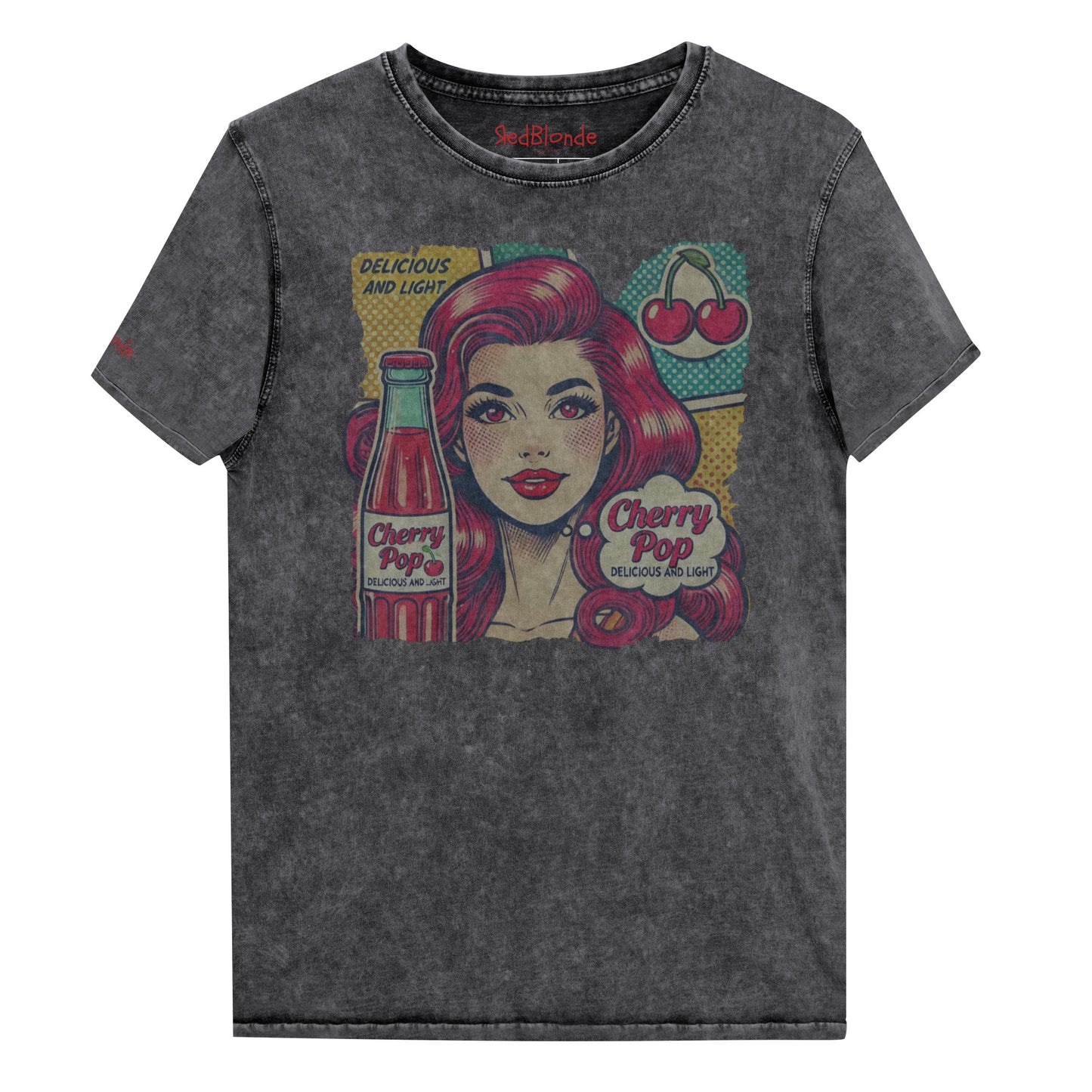 flatlay of unisex vintage black denim wash t-shirt with a pop-art graphic of a redheaded woman with a bottle of cherry pop, cherry graphic and the words 'Cherry Pop, delicious and light' in talk bubble. Branded RedBlonde on inside neck and right sleeve in red
