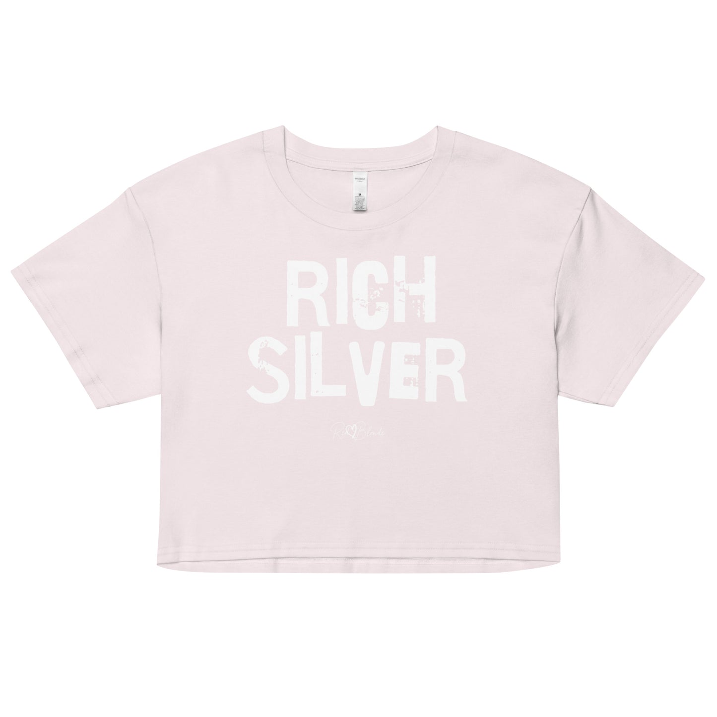 an orchid coloured crop top with a relaxed fit, short sleeves, and a wide crew neckline. The front features bold white distressed lettering reading “RICH SILVER” with the RedBlonde signature logo underneath in white