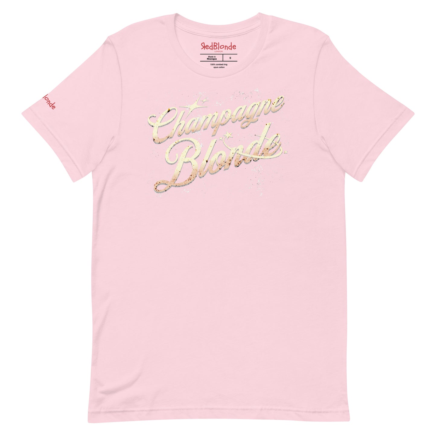 Flatlay of pale pink unisex relaxed fit t-shirt with 'Champagne Blonde' on an angle in Milkstore 01 font in a golden hue with a sprinkle of distressed stars. Branded RedBlonde London in red on inside neck and right sleeve.