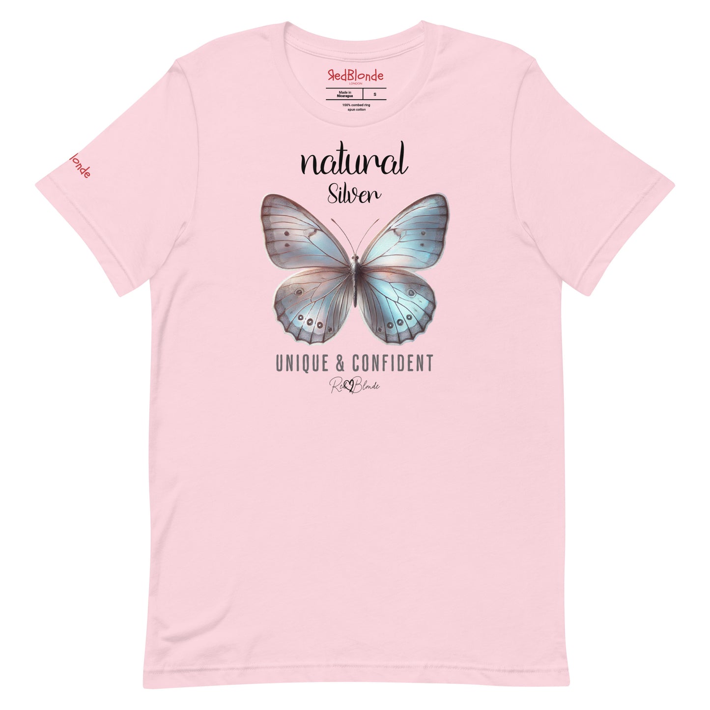 Flatylay of a pale pink unisex relaxed fit t-shirt with the words natural Silver in arionna font above a graphic of a silver butterfly with 'UNIQUE & CONFIDENT' below in adventurer 06 font signed off by RedBlonde. Branded RedBlonde London on inside neck and right sleeve