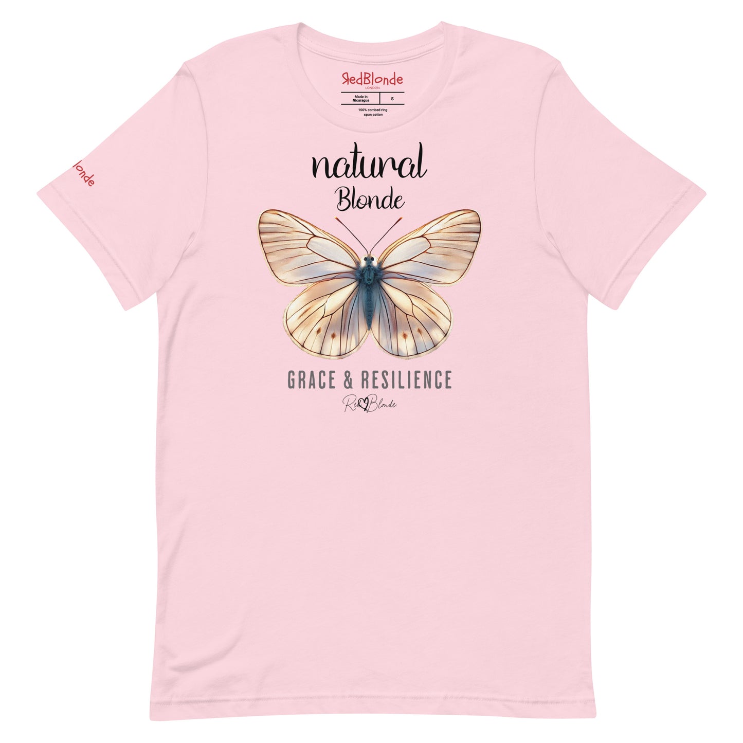 flatlay of a pale pink unisex relaxed fit t-shirt with the words natural blonde in arionna font above a graphic of a blonde butterfly with 'GRACE & RESILIENCE' below in adventurer 06 font signed off by RedBlonde. Branded RedBlonde London in red on inside neck and right sleeve