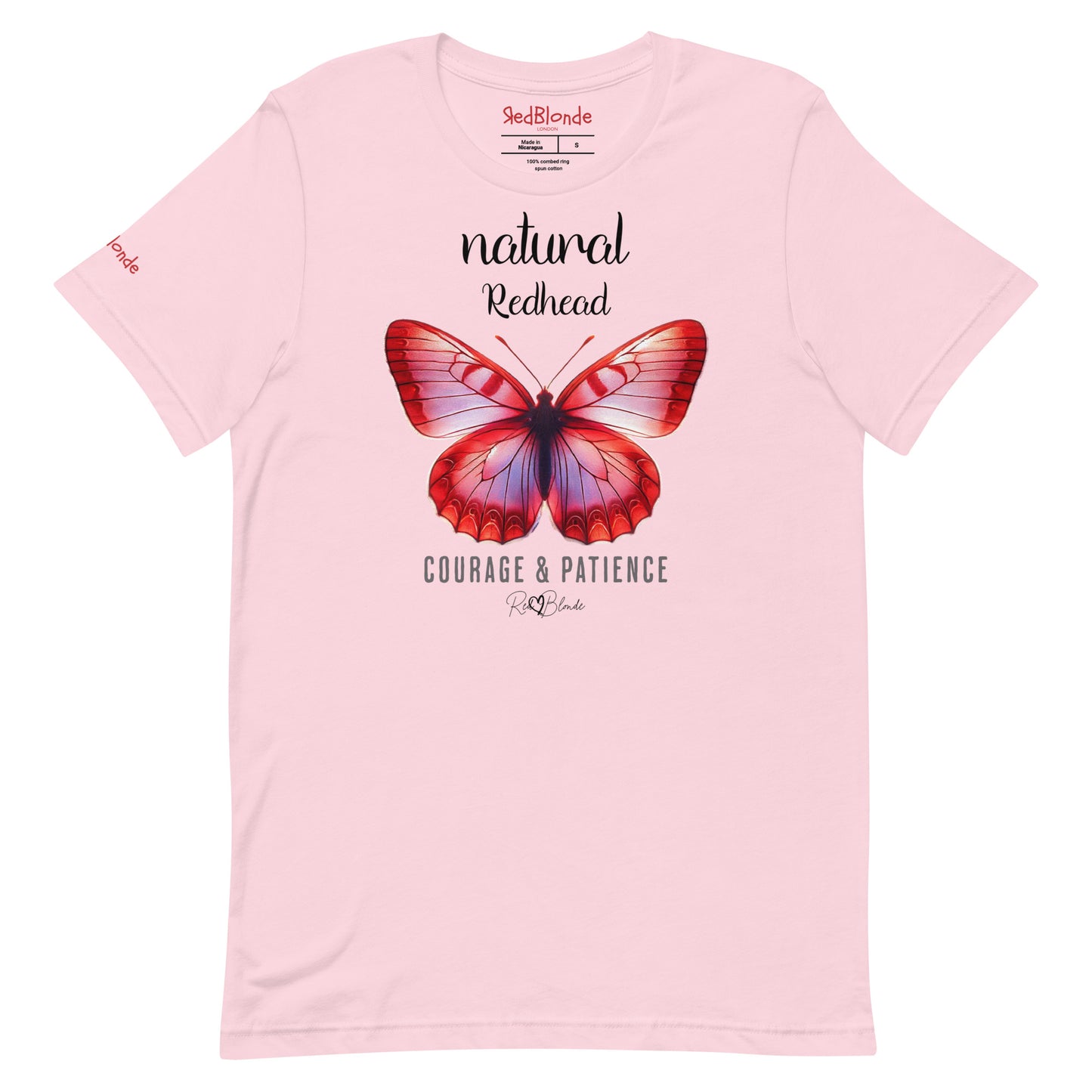 flatlay of pale pink unisex relaxed fit t-shirt with the words natural redhead in arionna font above a graphic of a red butterfly with 'COURAGE & PATIENCE' below in adventurer 06 font. Signed off Redblonde.