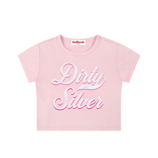pink short-sleeve crop T-shirt with large cursive “Dirty Silver” Milkstore text in white and pink on the front, and a small “RedBlonde London” label at the neckline.