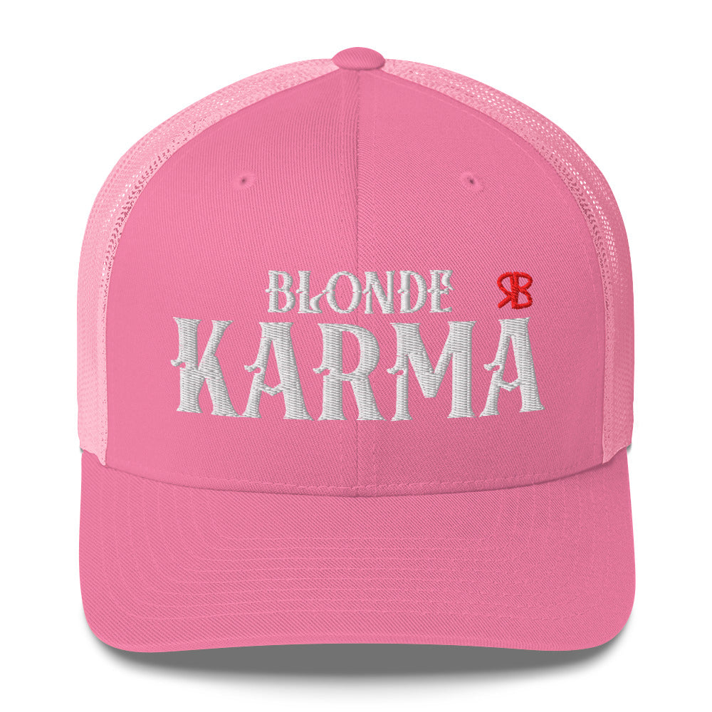 pink/white retro trucker cap with mesh back. The front features bold white embroidered text reading "BLONDE KARMA" with a small red RB logo to the right.