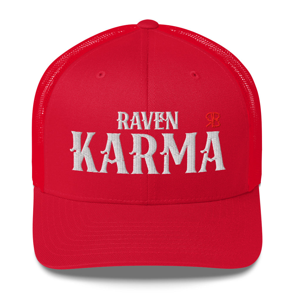 red retro trucker cap with mesh back. The front features bold white embroidered text reading "RAVEN KARMA" with a small red RB logo to the right.
