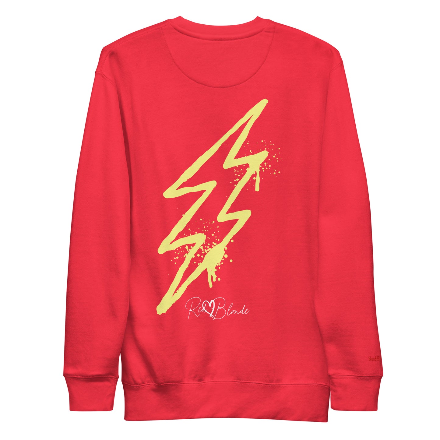 Back view of a red unisex sweatshirt featuring a bold yellow lightning bolt graphic with paint-splatter detail and the RedBlonde logo printed below. The design has an edgy, electric streetwear vibe. Branded RedBlonde in red on right sleeve