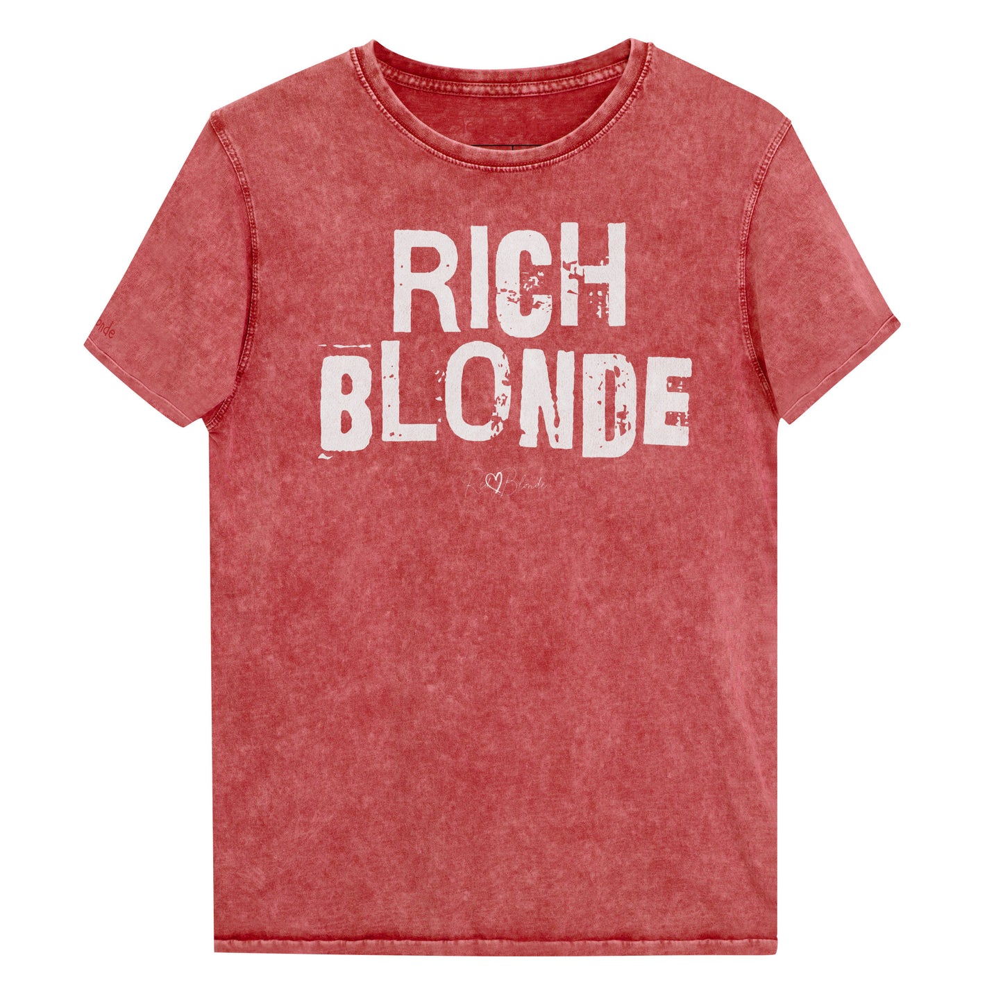Blonde wears a red acid-wash unisex denim T-shirt with a distressed vintage look. The shirt features "RICH BLONDE" in bold white Ed Gein font with the RedBlonde signature logo underneath. The shirt has short sleeves, a crew neckline, and visible seam detailing for a rugged, casual style. Branded Redblonde on inside neck and right sleeve
