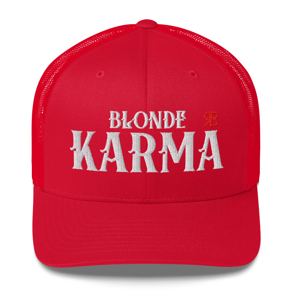 red retro trucker cap with mesh back. The front features bold white embroidered text reading "BLONDE KARMA" with a small red RB logo to the right.