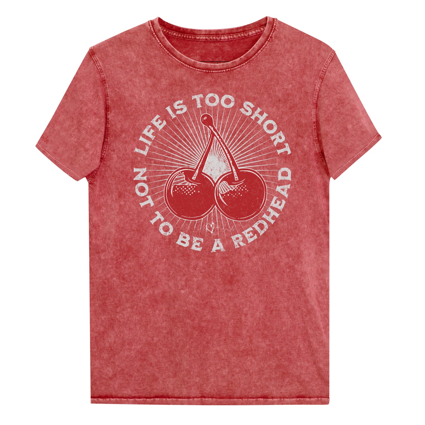 red garnet acid-wash unisex T-shirt featuring a bold red cherry graphic in the center. Surrounding text reads “Life is too short not to be a redhead” in distressed white adventure font lettering. The inside neck and sleeve also feature the RedBlonde logo in red.