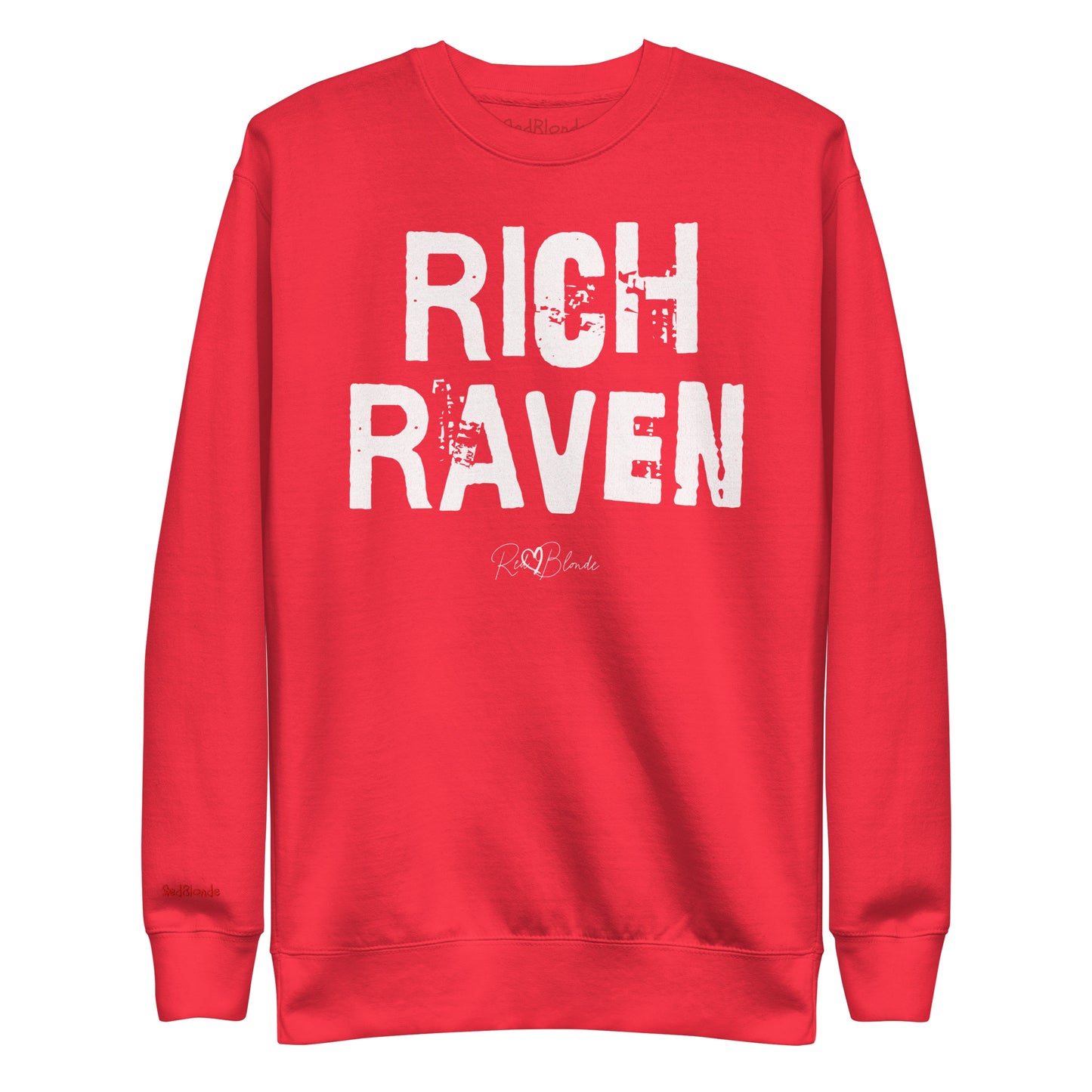 red unisex premium sweatshirt with bold distressed white Ed Geinitext “RICH RAVEN” on the front, featuring a subtle RedBlonde logo beneath the lettering and on the sleeve cuff and inside neck
