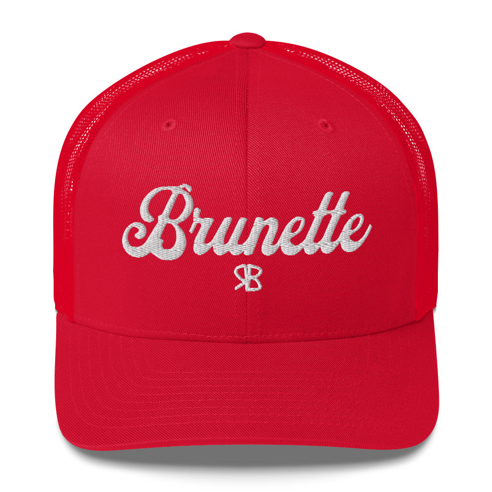 red trucker cap with 'Brunette' in white adventurer 01 font on front. Branded RB