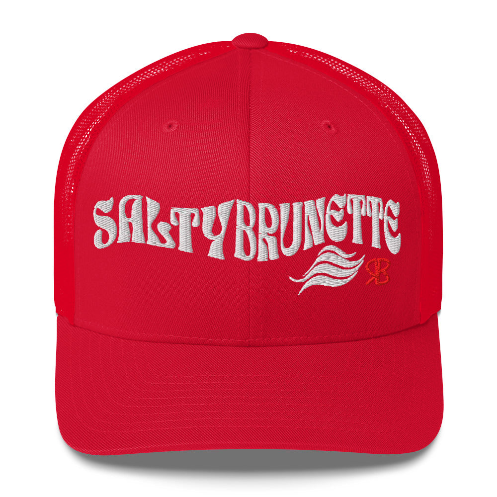 red trucker cap with 'Salty Brunette' in white Solino display font. Branded RB in red