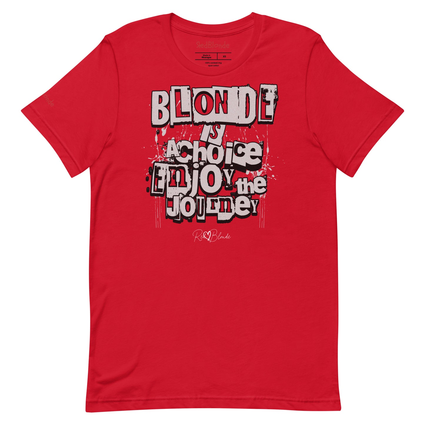 A red unisex T-shirt with a classic crew neckline and short sleeves. The front displays a bold, graffiti-style text design in black, white, and gray. The words read: “BLONDE is a choice, ENJOY the JOURNEY” with varied fonts and a layered street-art effect. The RedBlonde brand name is subtly printed below in a handwritten script. Branded RedBlonde london in red on inside neck and right sleeve