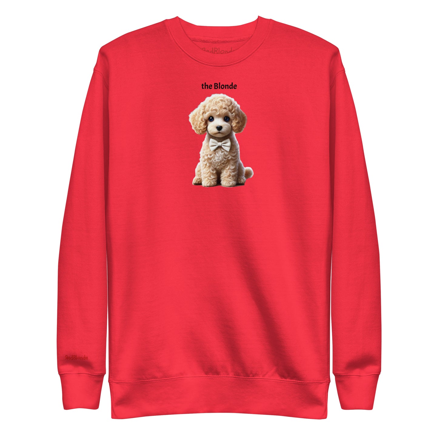 Flatlay of red relaxed fit unisex sweatshirt with a cute graphic of a Blonde Puppy wearing a bow-tie and the words 'the Blonde' linking to Blonde hair. Branded RedBlonde in red on inside neck and right cuff