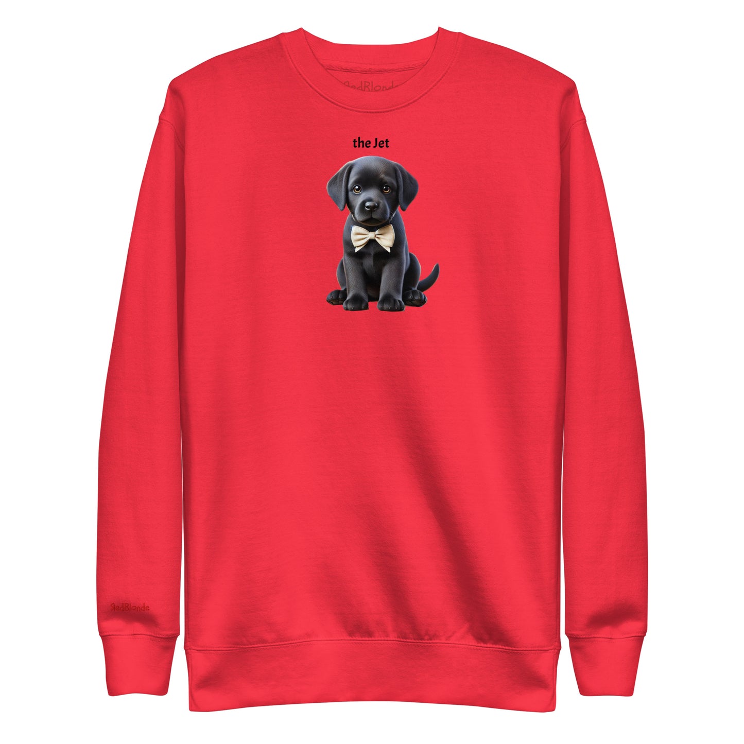Flatlay of red relaxed fit unisex sweatshirt with a cute graphic of a Jet black puppy wearing a bow-tie and the words 'the Jet' linking to Black hair. Branded RedBlonde in red on inside neck and right cuff
