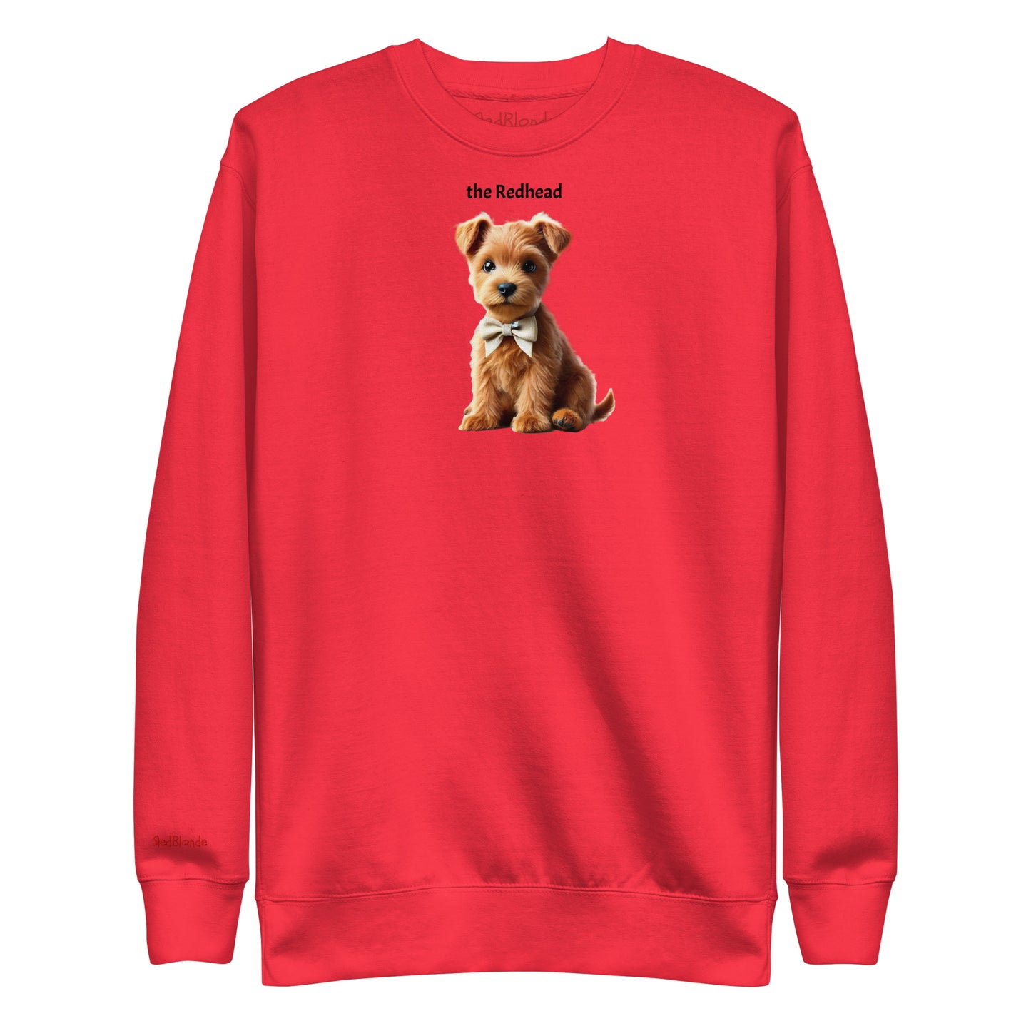 Flatlay of red relaxed fit unisex sweatshirt with a cute graphic of a Redhead Puppy wearing a bow-tie and the words 'the Redhead' linking to Red hair. Branded RedBlonde in red on inside neck and right cuff