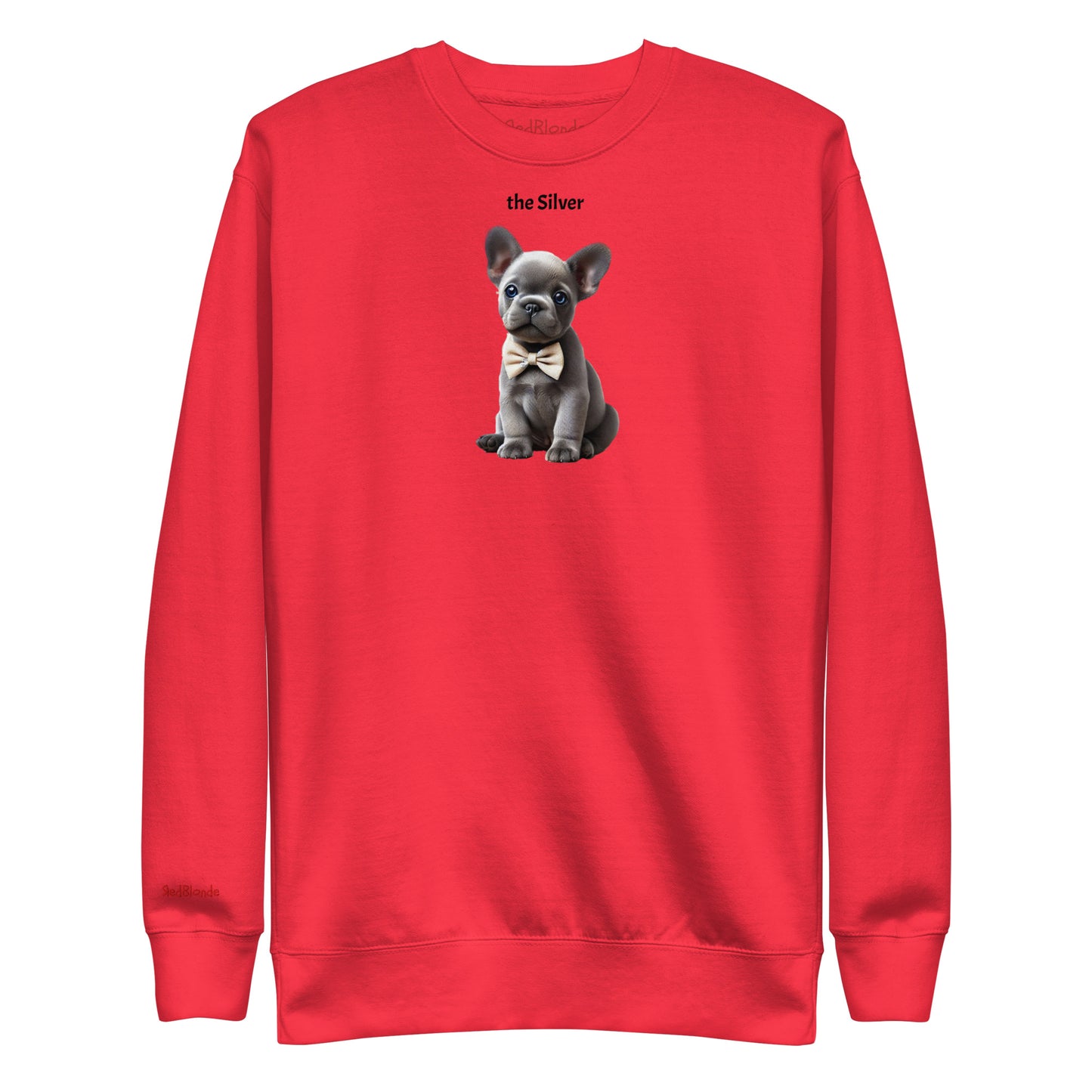 Flatlay of red relaxed fit unisex sweatshirt with a cute graphic of a Silver puppy wearing a bow-tie and the words 'the Silver' linking to silver hair. Branded RedBlonde in red on inside neck and right cuff