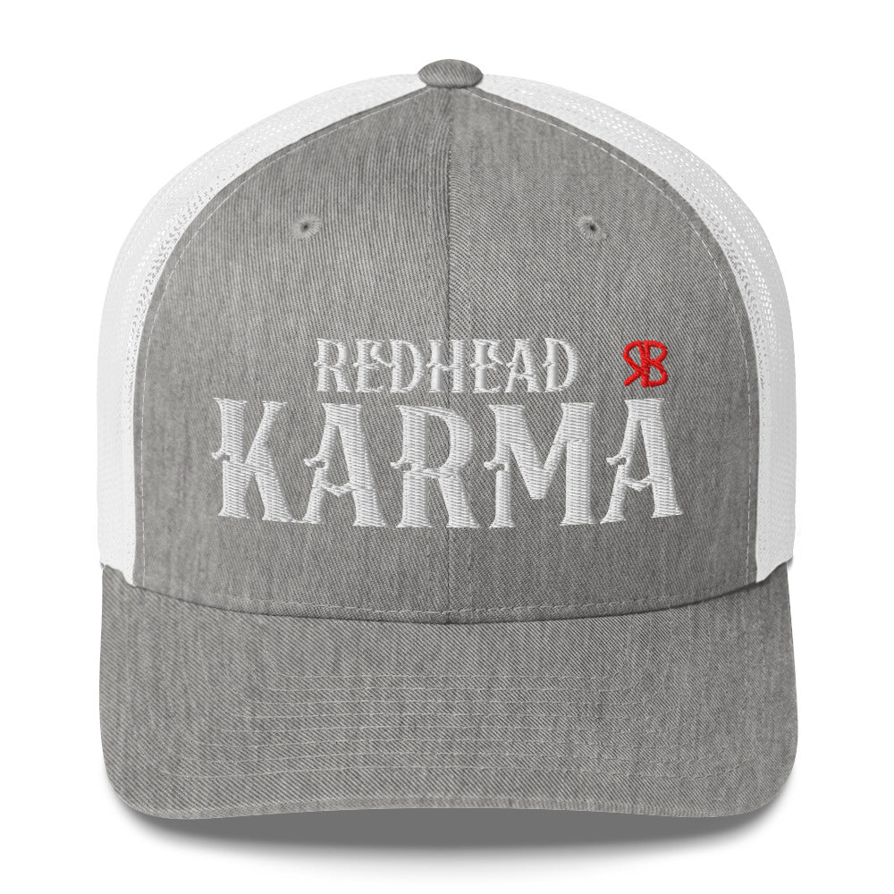 light grey/white retro trucker cap with mesh back. The front features bold white embroidered text reading "REDHEAD KARMA" with a small red RB logo to the right.