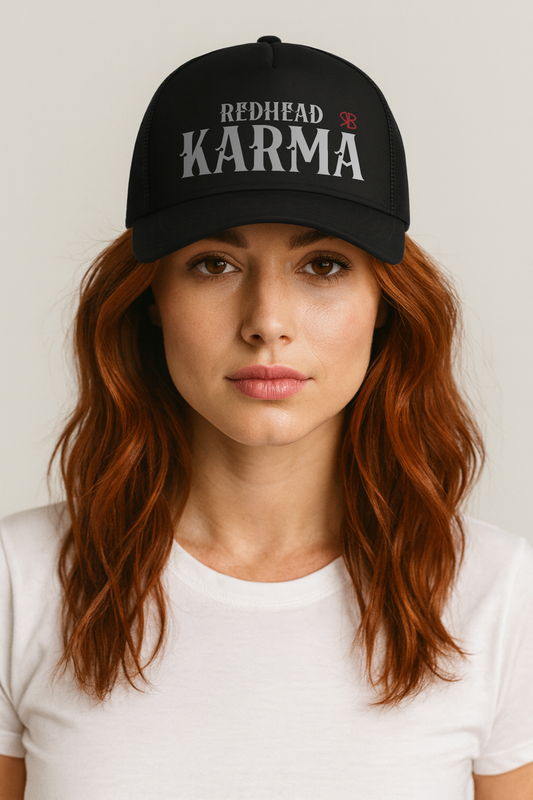 redwears wear a black retro trucker cap with mesh back. The front features bold white embroidered text reading "REDHEAD KARMA" with a small red RB logo to the right.
